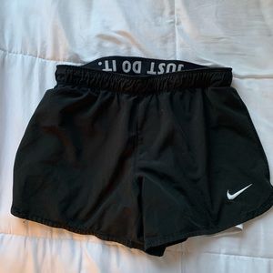 NIKE small black athletic shorts with built in white spandex